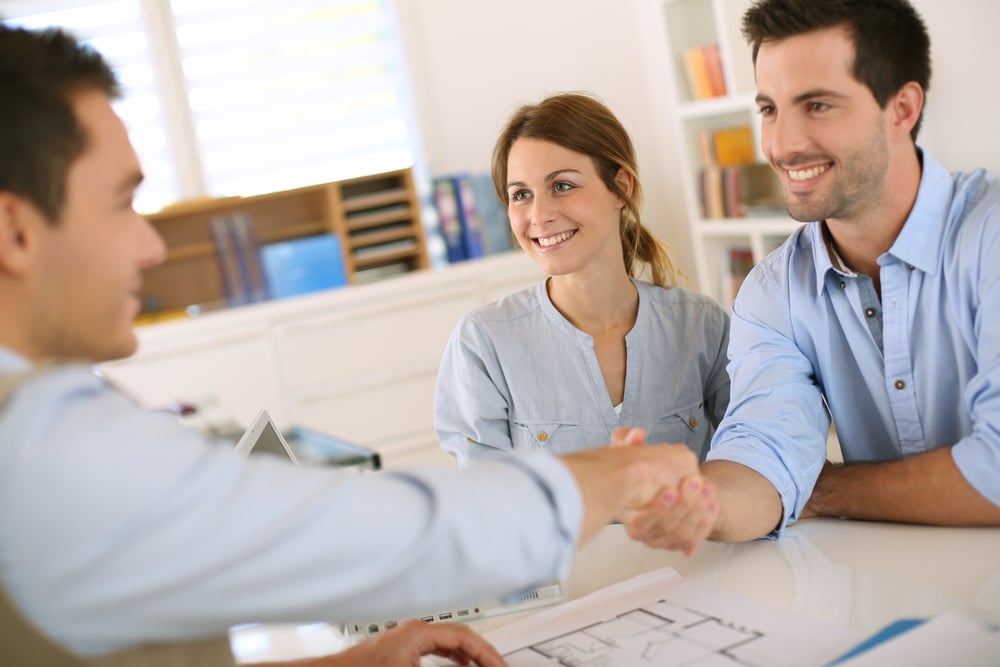 Young couple meeting construction planner